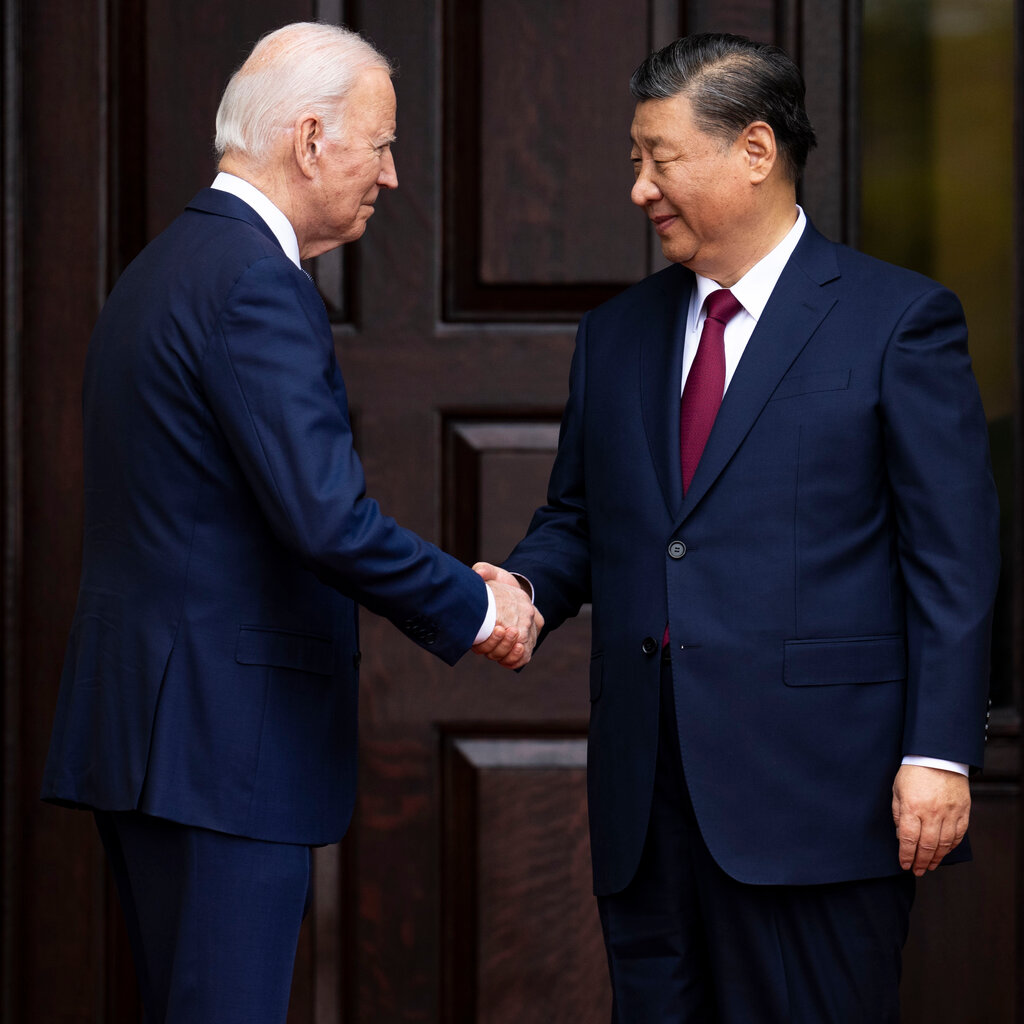 President Joe Biden greets President Xi Jinping of the People’s Republic of China shake hands. 