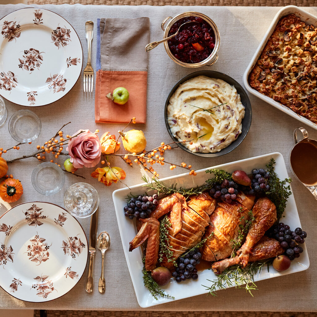 A top-down view of a spread of Thanksgiving food, including turkey and mashed potato.