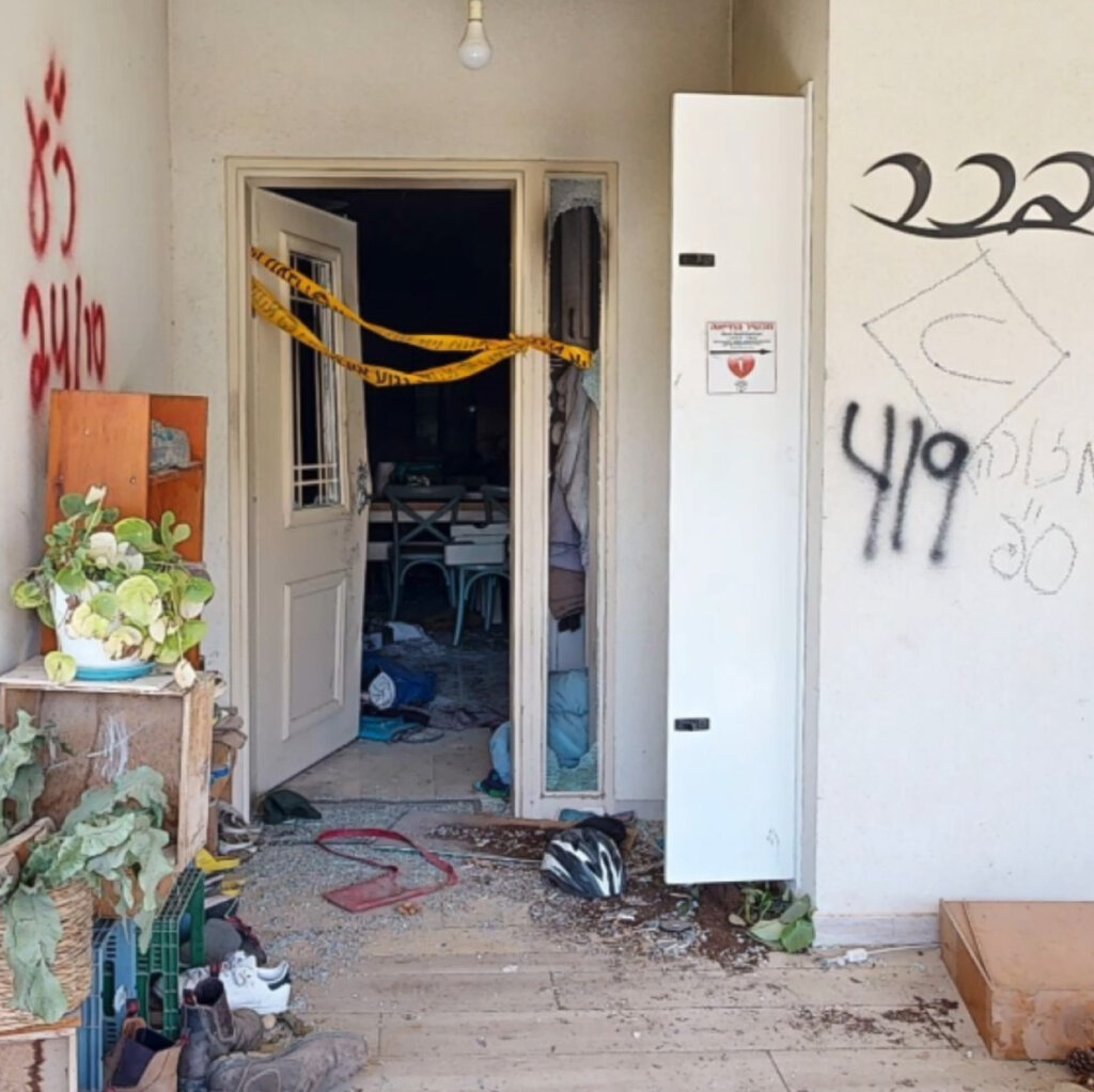 An open doorway with debris and caution tape.