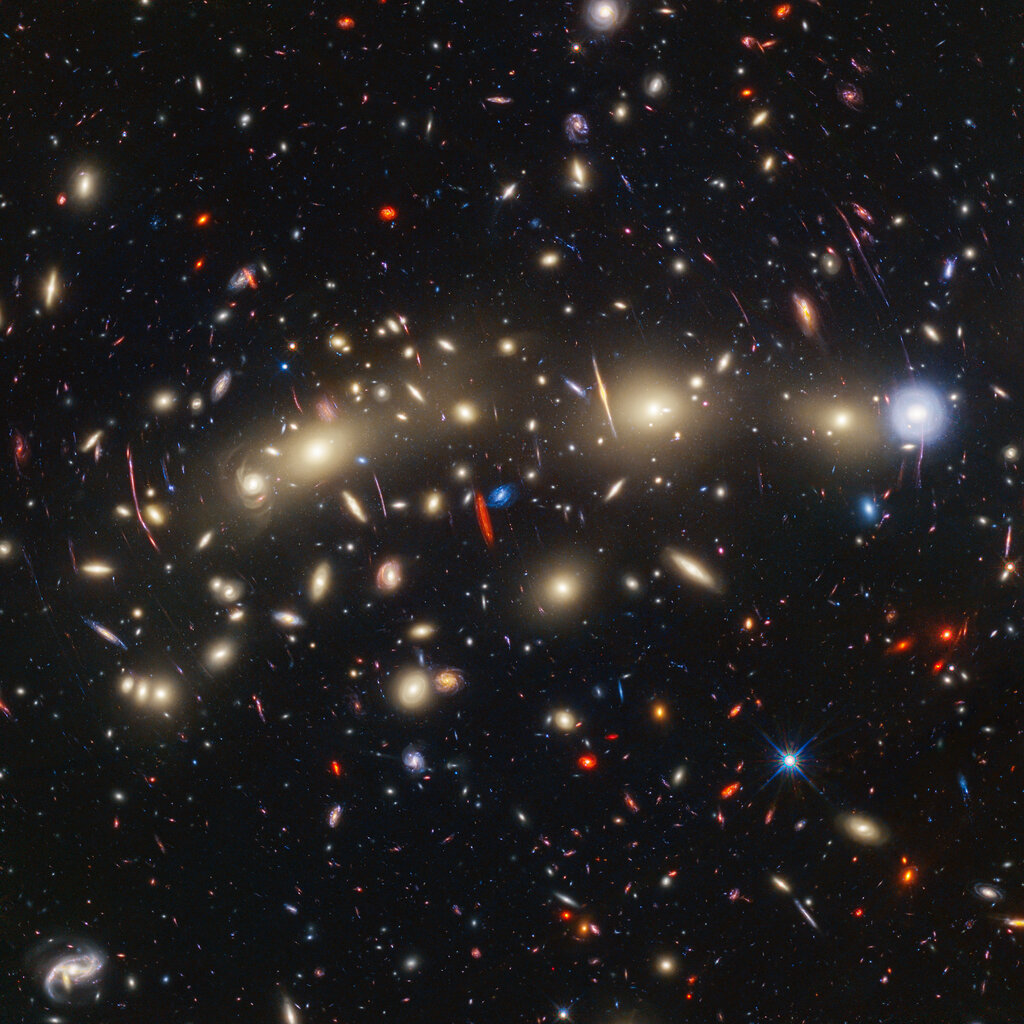 A black sky with dozens of galaxies.