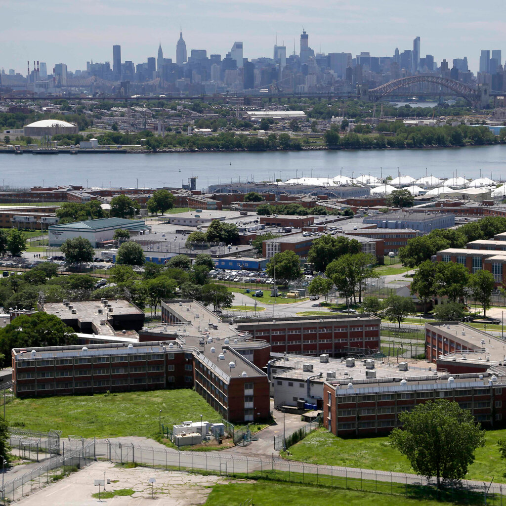 A view of Rikers Island with the Manhattan skyline in the background.