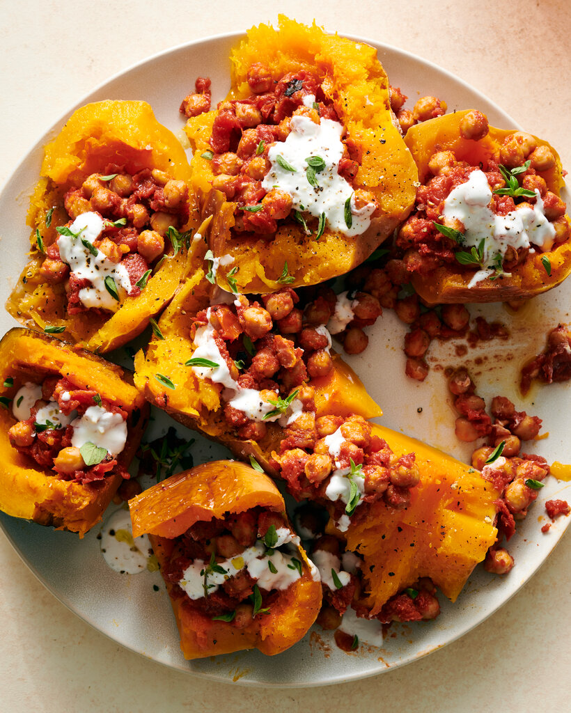 A plate with squash, chickpeas, and an herb garnish.
