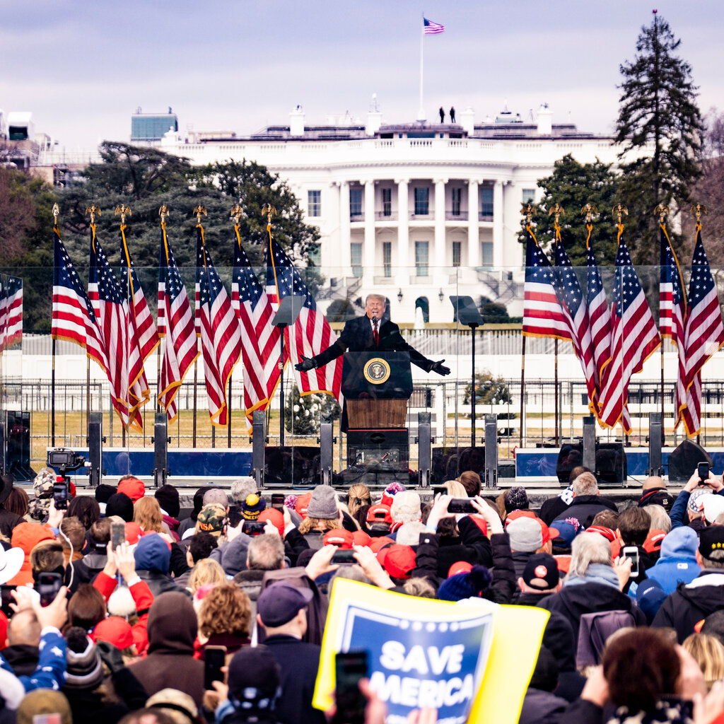 Donald Trump speaking to a crowd in front of the White House. 