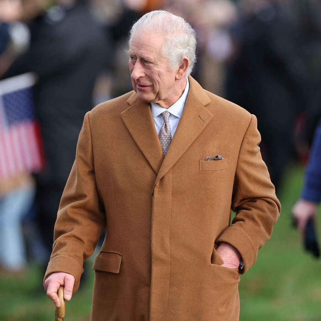 King Charles dressed in a camel-color overcoat.