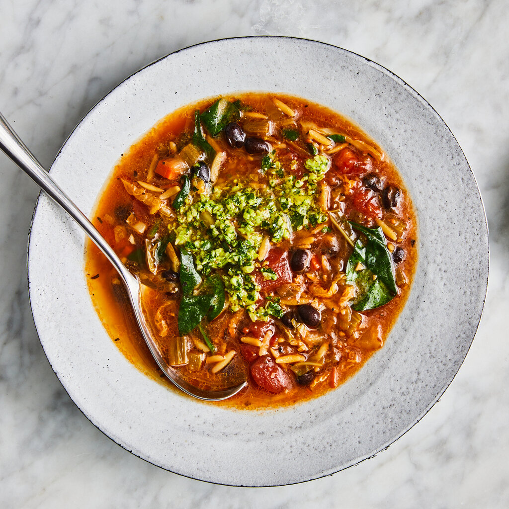 A bowl of minestrone with cabbage pesto.