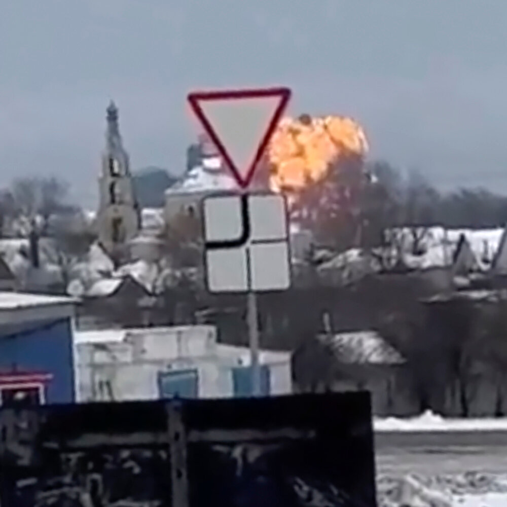 A video still showing a fireball visible over the snowy roofs of a small town.