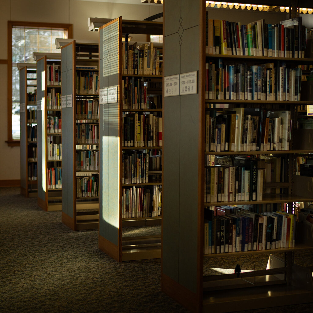 A line of bookshelves in a library.