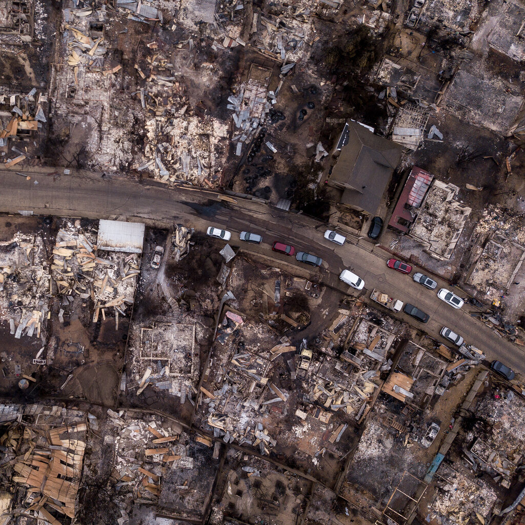 Fire-damaged buildings, almost totally destroyed, seen from above.