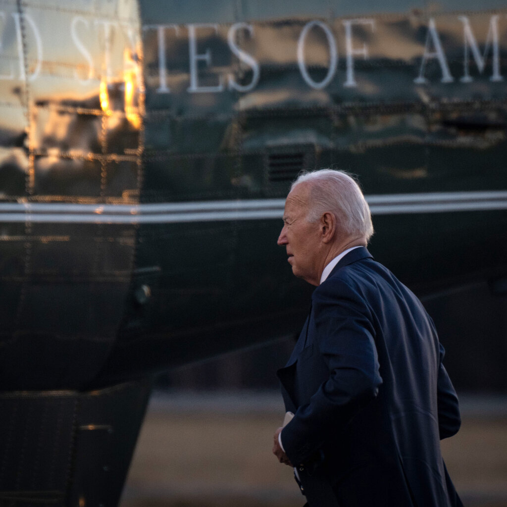 Side profile of President Joe Biden walking toward Marine One. 