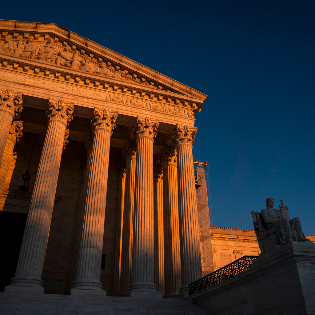 The exterior of the U.S. Supreme Court building at sunset.
