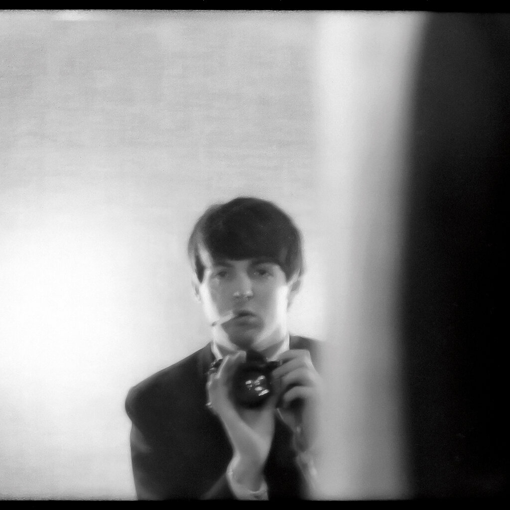 A Paul McCartney self-portrait in a mirror, Paris, 1964, with a cigarette hanging from his lip. 