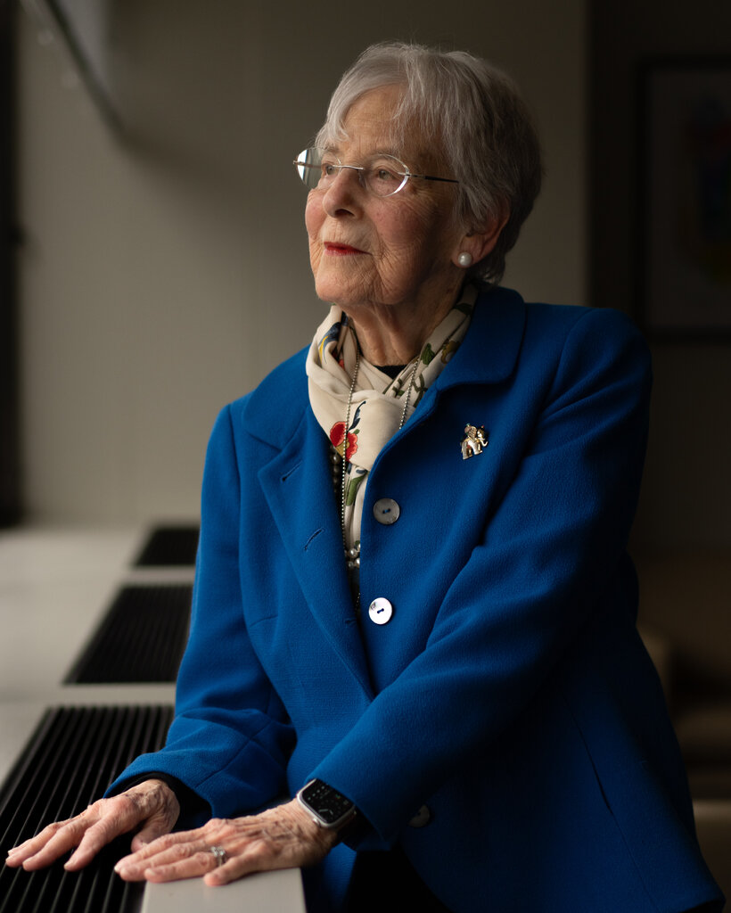 Ruth Gottesman, in a royal blue jacket and white scarf, poses for a portrait.
