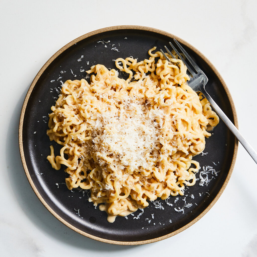 Creamy noodles topped with grated cheese.