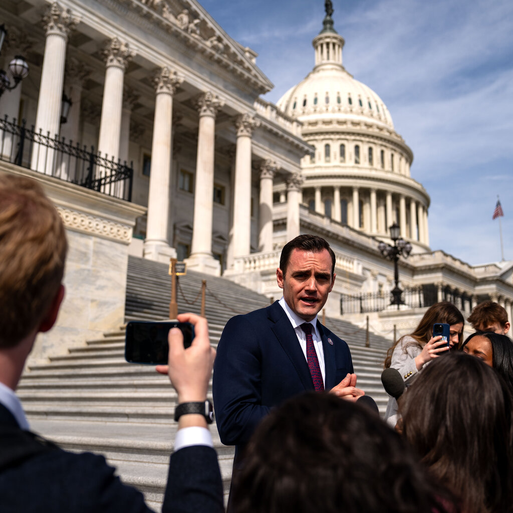 Representative Mike Gallagher speaks with reporters on the steps of the House of Representatives.