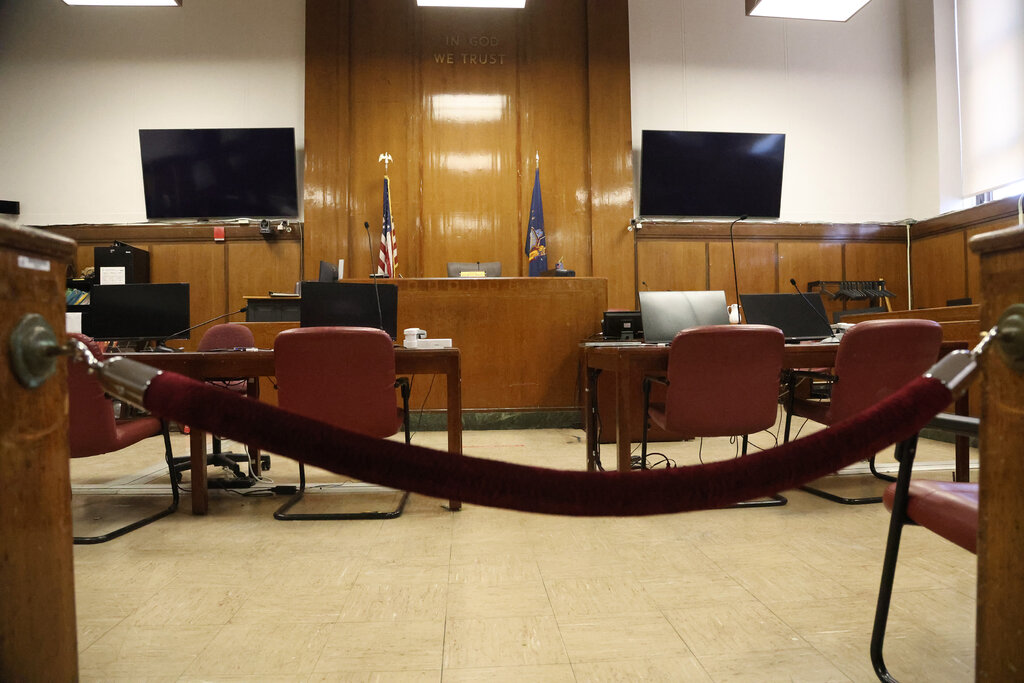 An empty courtroom, behind a velvet rope.