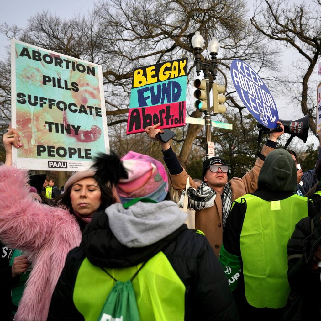 Demonstrators holding signs supporting and against abortion rights.