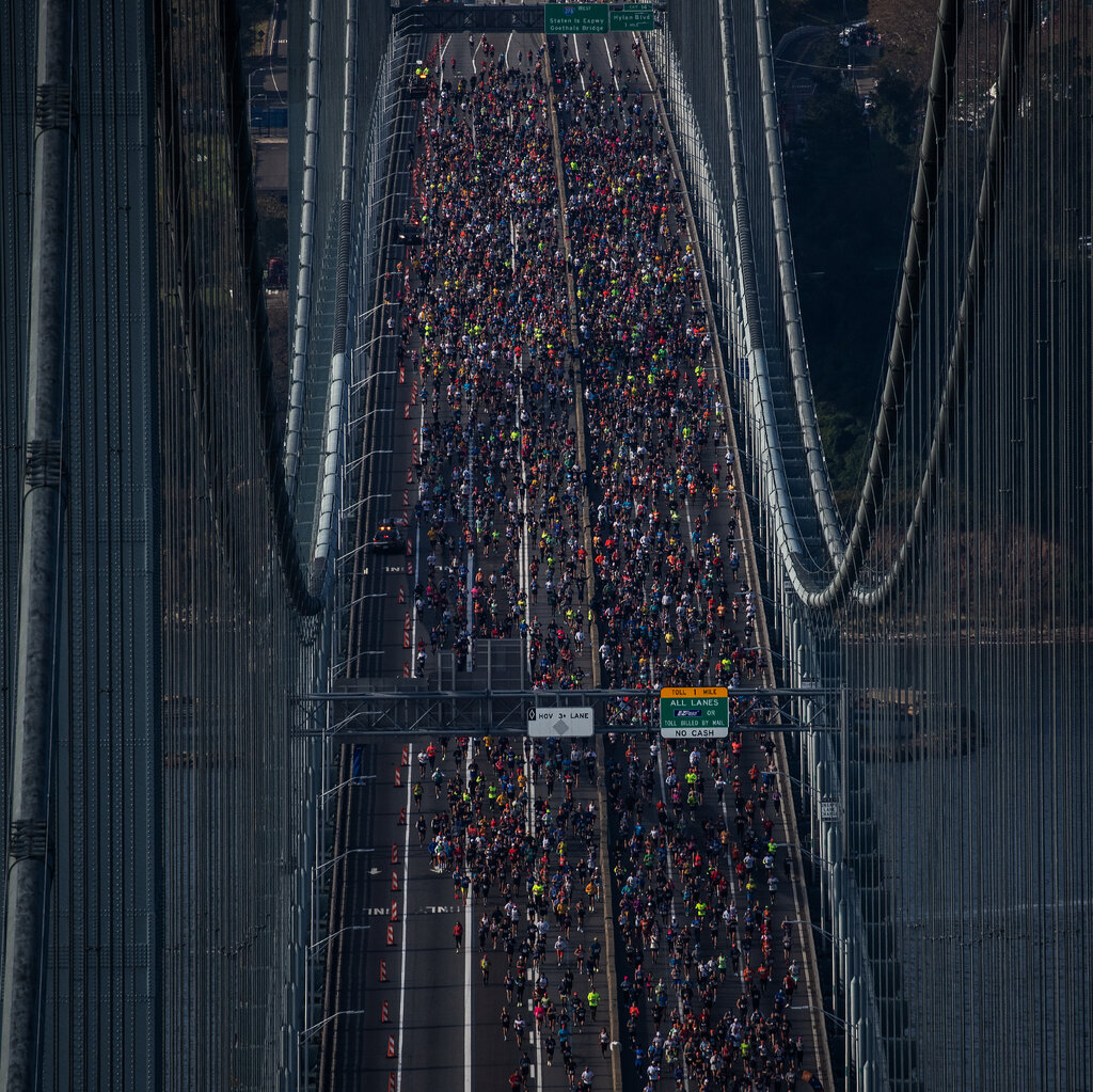 An overhead shot of runners crossing the Verrazzano-Narrows Bridge, with much of the upper roadway covered by participants.