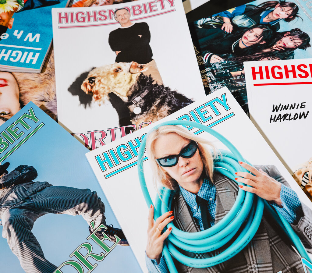 Issues of Highsnobiety magazine strewed across a desk.