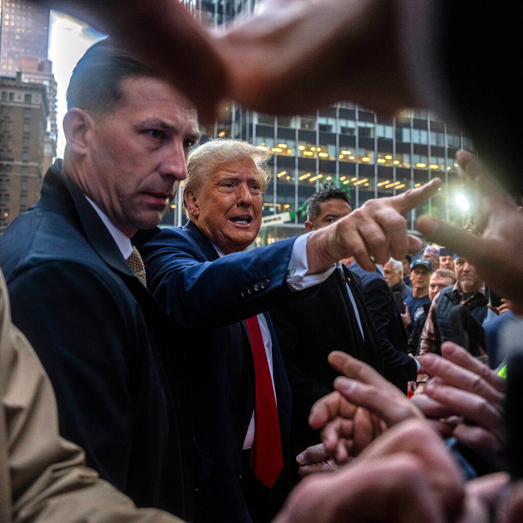 Donald Trump wearing a suit meets with Union workers in Manhattan before attending his trial.