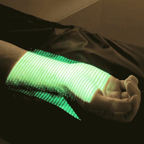 A person's hand being scanned with green X-ray-looking lines on his arm. 