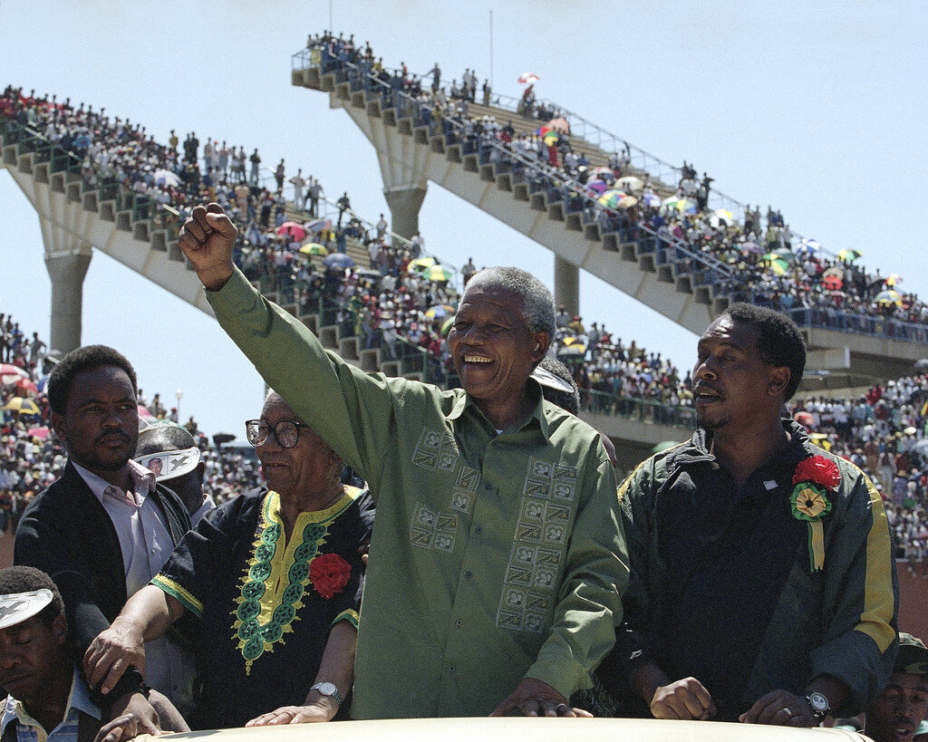 Nelson Mandela waves to supporters on his arrival at an election rally in Mabopane, North of Pretoria, in March, 1994.