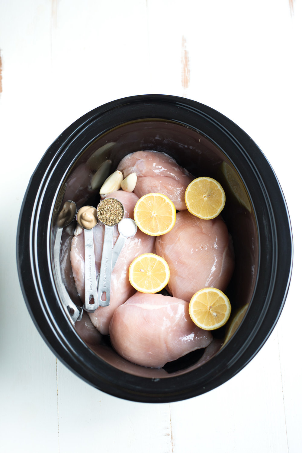 Bright, tangy, and crazy simple to make, Slow Cooker Lemon Herb Pulled Chicken is a no-fuss weeknight dinner everyone will love. Read on for the chicken recipe, plus 3 ways to use it, so you can cook once and eat well all week!