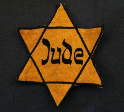 In November 1939, the Nazi government first introduced mandatory ID badges for Jews in Poland.  The yellow badge was considered to be one  step in the Final Solution as it enabled them to isolate the Jews.  To enforce compliance, they announced, "Severe punishment is in store for  Jews who do not wear the yellow badge on back and front."  (Jewish Virtual Library)