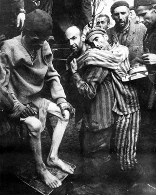 Former prisoners of the Wobbelin Concentration Camp in  Germany are taken to a hospital for medical attention, after being rescued by troops of the 82nd Airborne Division.  Many prisoners were found almost starved to death.