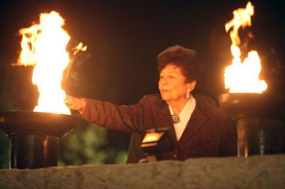 A Holocaust survivor lights a torch at Yad Vashem (The Holocaust  Martyrs' and Heroes' Remembrance Authority).  Six torches are lit on  Israel's Holocaust Remembrance Day in memory of the six million Jews who were murdered in the Holocaust.