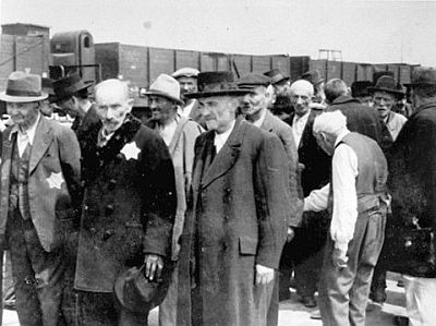 Russian Jewish men await selection at Auschwitz, the largest camp  established by the Germans.  After disembarking from the trains, being  sent to the right meant forced labor.  Being sent to the left meant death in  the gas chambers.  This camp was located 37 miles (60 km) west of Krakow, near the prewar German-Polish border.