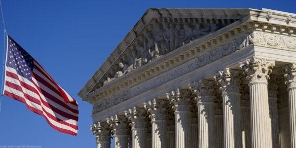 A half-lowered US flag waves in front of the US Supreme Court. A half-lowered US flag waves in front of the US Supreme Court.