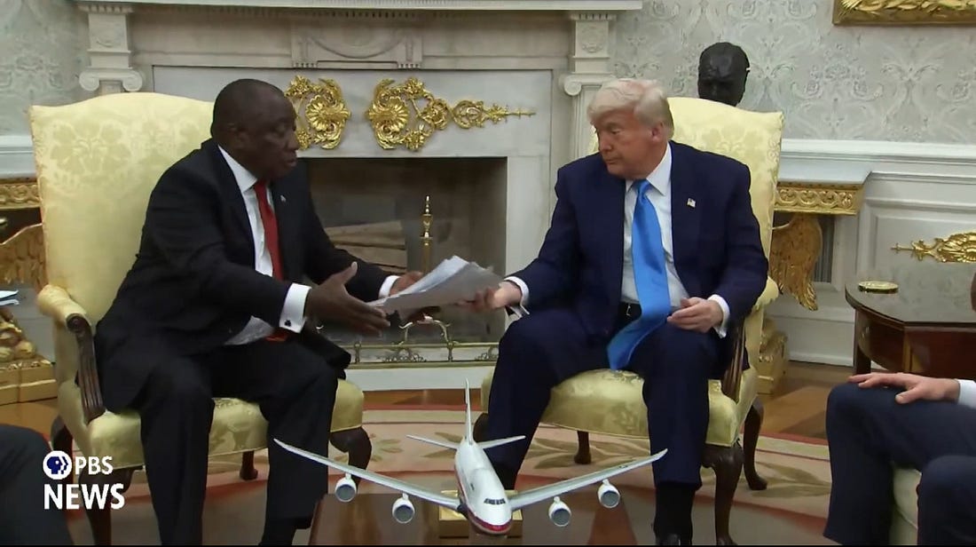 Trump handing South African President Cyril Ramaphosa a stack of articles Trump handing South African President Cyril Ramaphosa a stack of articles