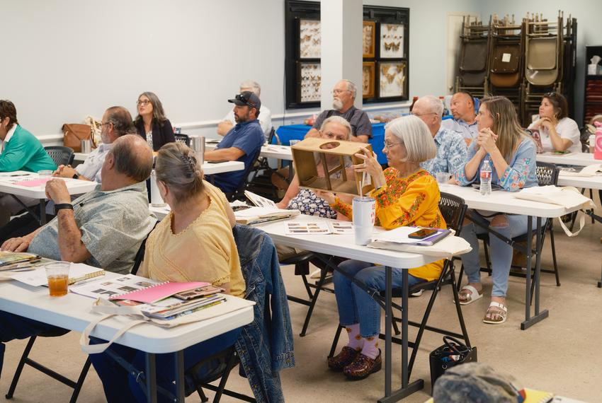 Students inspect a piece of beekeeping equipment during a ‘Bee Keeping 101’ class in San Antonio on Thursday, May 9, 2024