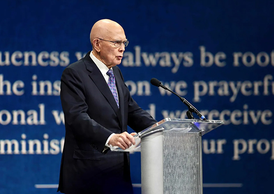 President Dallin H. Oaks delivers a BYU devotional address from the podium in the Marriott Center.