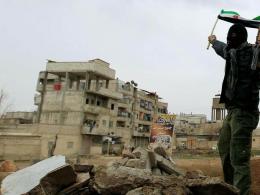 a-syrian-soldier-who-has-defected-to-join-the-free-syrian-army-holds-up-his-rifle-and-waves-a-syrian-independence-flag-in-saqba-in-damascus-suburbs-enero-2012.jpg