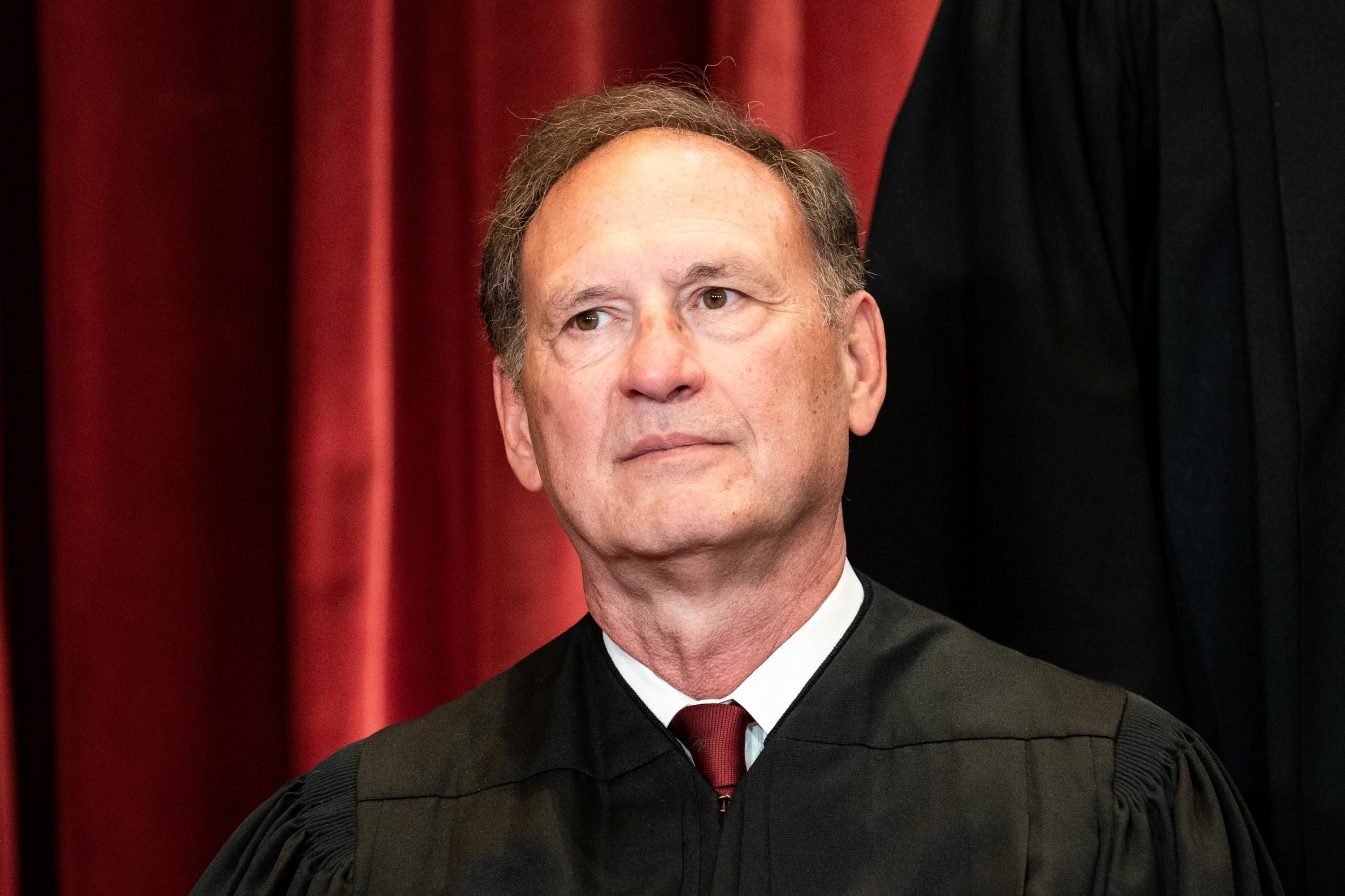 Supreme Court Justice Samuel Alito sits during a group photo