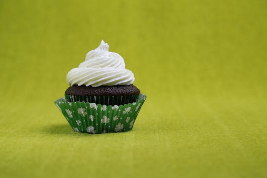 Guinness cupcakes topped with frosting made with Irish cream liqueur.
