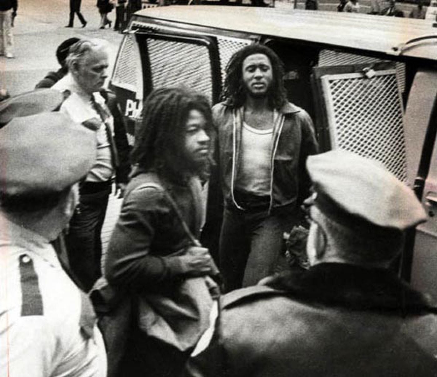 Delbert                       Africa (center) glares at deputies as he and                       Chuckie Africa leave court at City Hall during                       their 1979 trial for the murder of Officer James                       Ramp. Nine MOVE members were convicted.