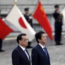 Chinese Premier Li Keqiang and Prime Minister Shinzo Abe observe an honor guard in Tokyo on May 9.