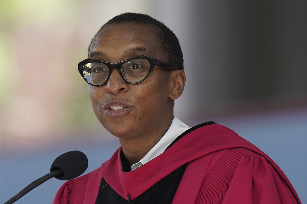 Claudine Gay, Harvard president, wears commencement regalia and speaks at a podium.