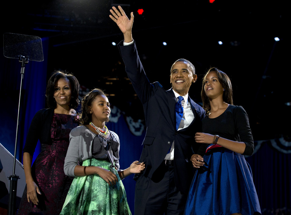 On this date in 2012: President Barack Obama wins re-election, waving as he walks on stage with first lady Michelle Obama and daughters Malia and Sasha. 