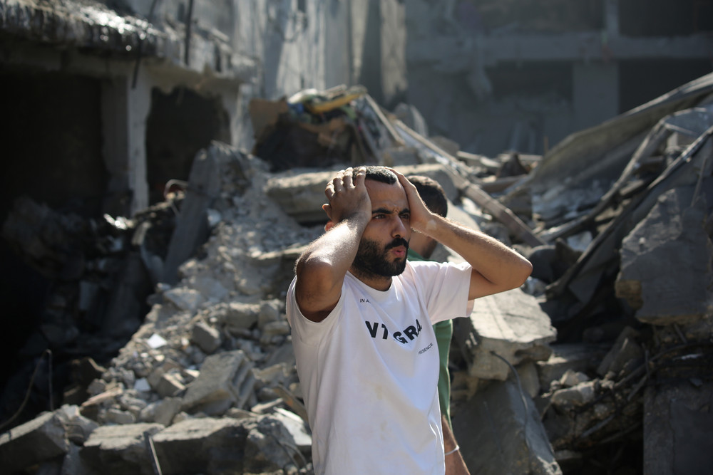 Palestinian citizens inspect damage to their homes caused by Israeli airstrikes on October 12 in Gaza City.