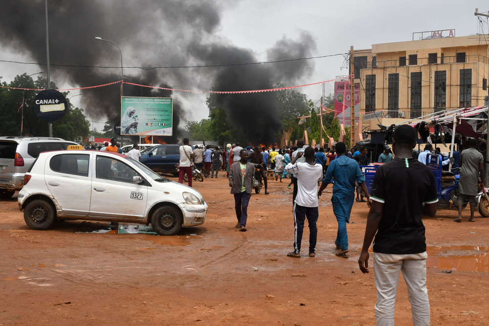 Supporters of the Nigerien defense and security forces attack the headquarters of the Nigerien Party for Democracy and Socialism in Niamey on July 27, 2023. 