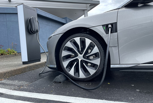 An electric vehicle sits parked at a charging station in Corte Madera, Calif. 