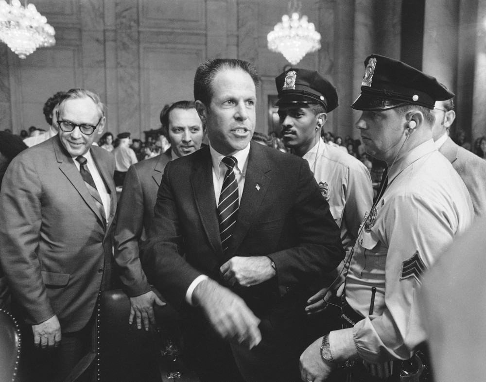 On this date in 1973: H.R. Haldeman, former top White House aide, is escorted from the Senate Caucus room by Capitol police after he completed his testimony before the Senate Watergate committee. 