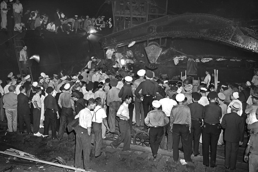On this date in 1943: Rescue crews dig through debris of the wrecked Pennsylvania Railroad's Congressional Limited in search of victims of a train derailment. The train, which had 541 passengers on board, derailed in Frankford Junction, Philadelphia, killing 79 passengers and injured 117 others. 