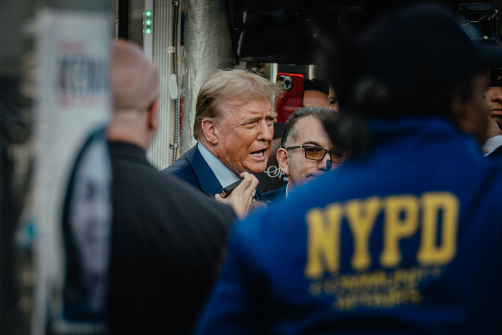 Former President Donald Trump speaks outside the Sanaa Convenient Store in the Harlem neighborhood of New York City.