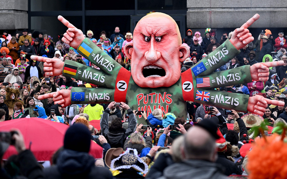 Revelers celebrate around a float featuring Russian oligarch Yevgeny Prigozhin, co-founder of the Wagner Group, who has six arms with the flags of Ukraine, Germany, Europe, NATO, the U.S. and Britain, equating them all with nazis, during a street carnival parade in Düsseldorf, Germany in February. 