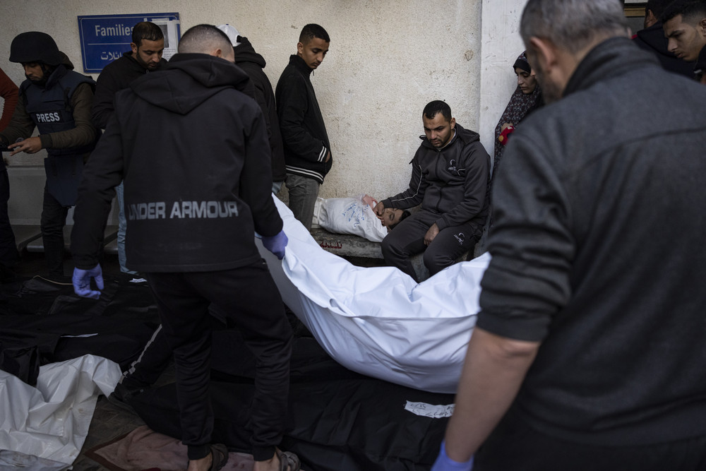 Palestinians mourn relatives killed in the Israeli bombardment of the Gaza Strip at a hospital morgue in Rafah on Feb. 12, 2024.  