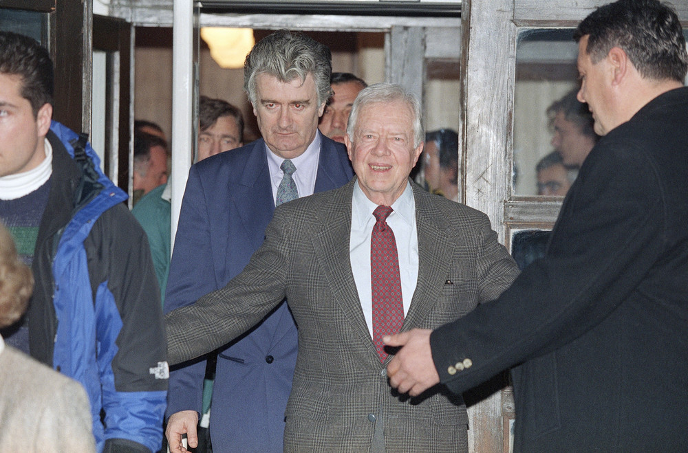 On this date in 1994: Former President Jimmy Carter smiles as he walks out of the Bosnian Serbs headquarters while Bosnian Serb leader Radovan Karadžić follows after a meeting. Carter traveled to Bosnia to help broker peace in the midst of sectarian violence in the region, and said that Karadžić had agreed to a four-month nationwide cease-fire. Karadžić was later convicted of genocide, crimes against humanity and war crimes by the ICC for
 his part in the directed extermination of non-Serbs in the region.